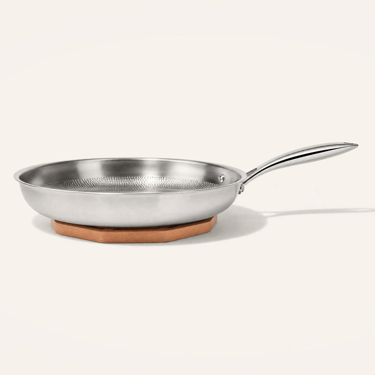 Titanium frying pan resting on the cherry wood trivet