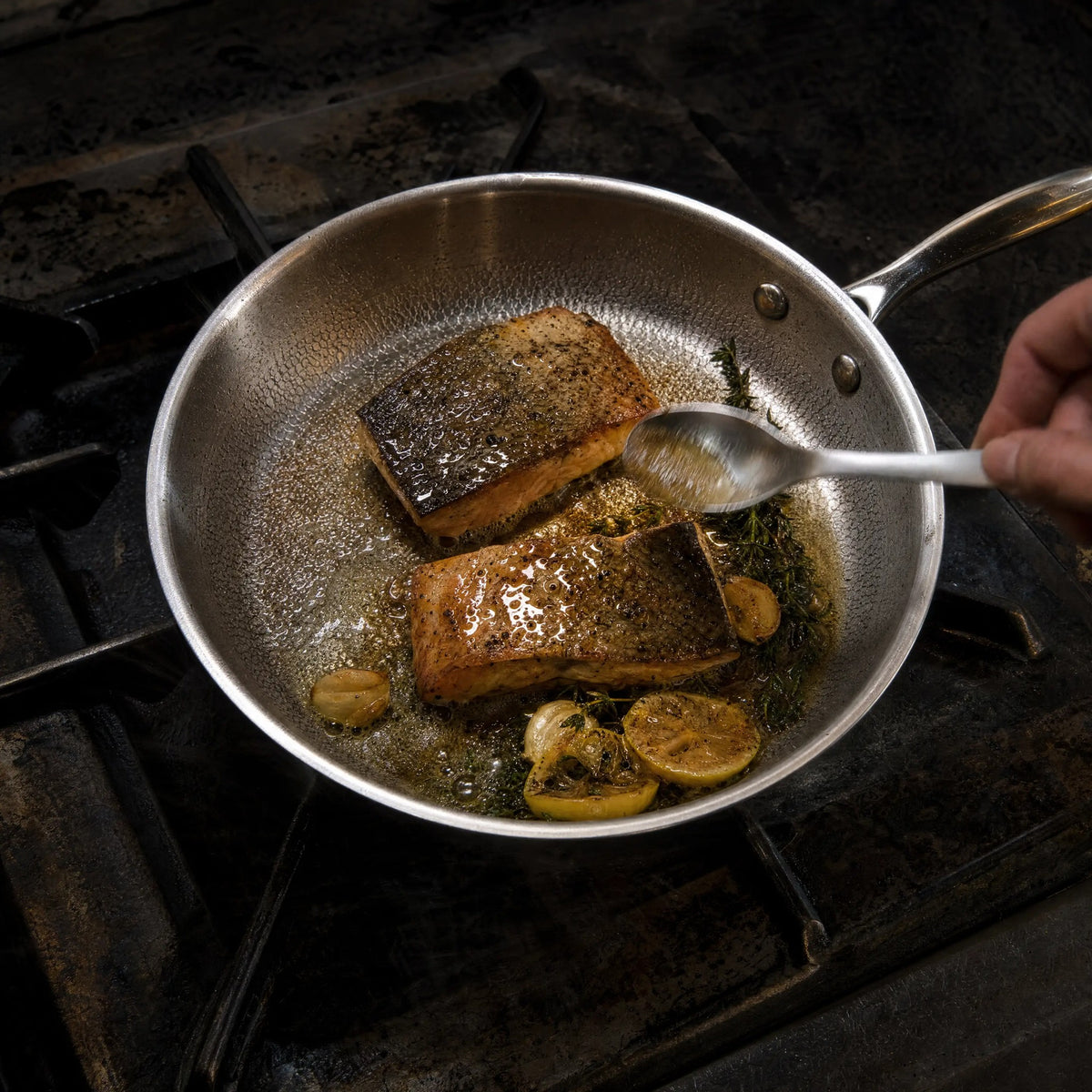 Titanium frying pan with butter basted crispy salmon