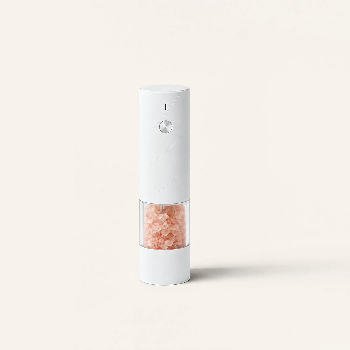 White electric salt mill with pink Himalayan salt on a cream background