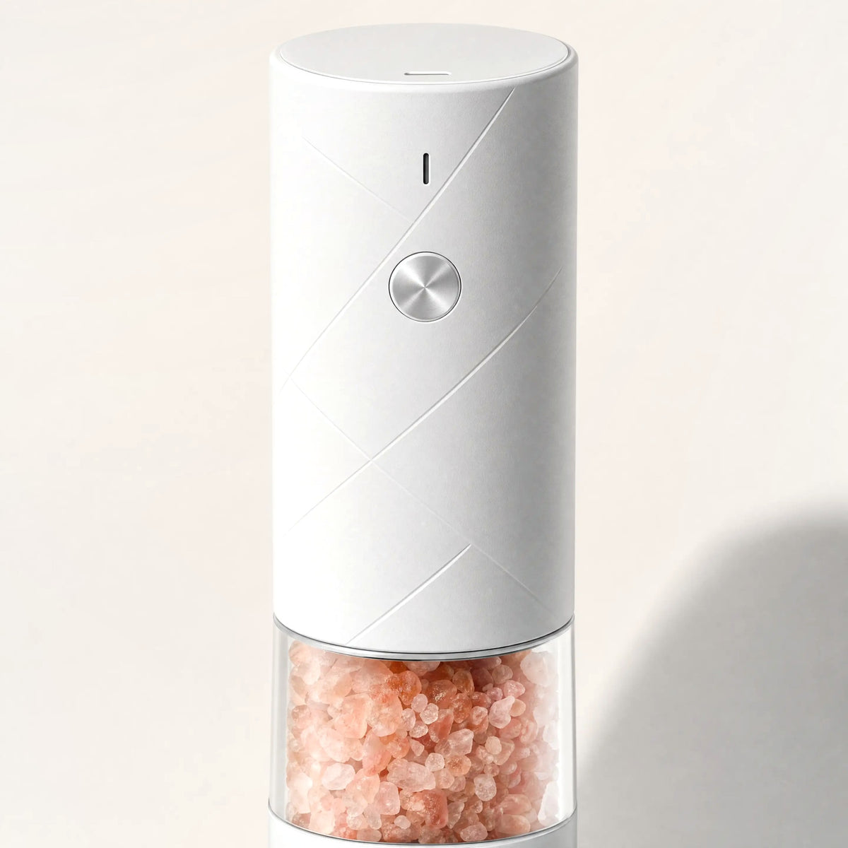 Close up of the push button and clear chamber of the electric salt mill