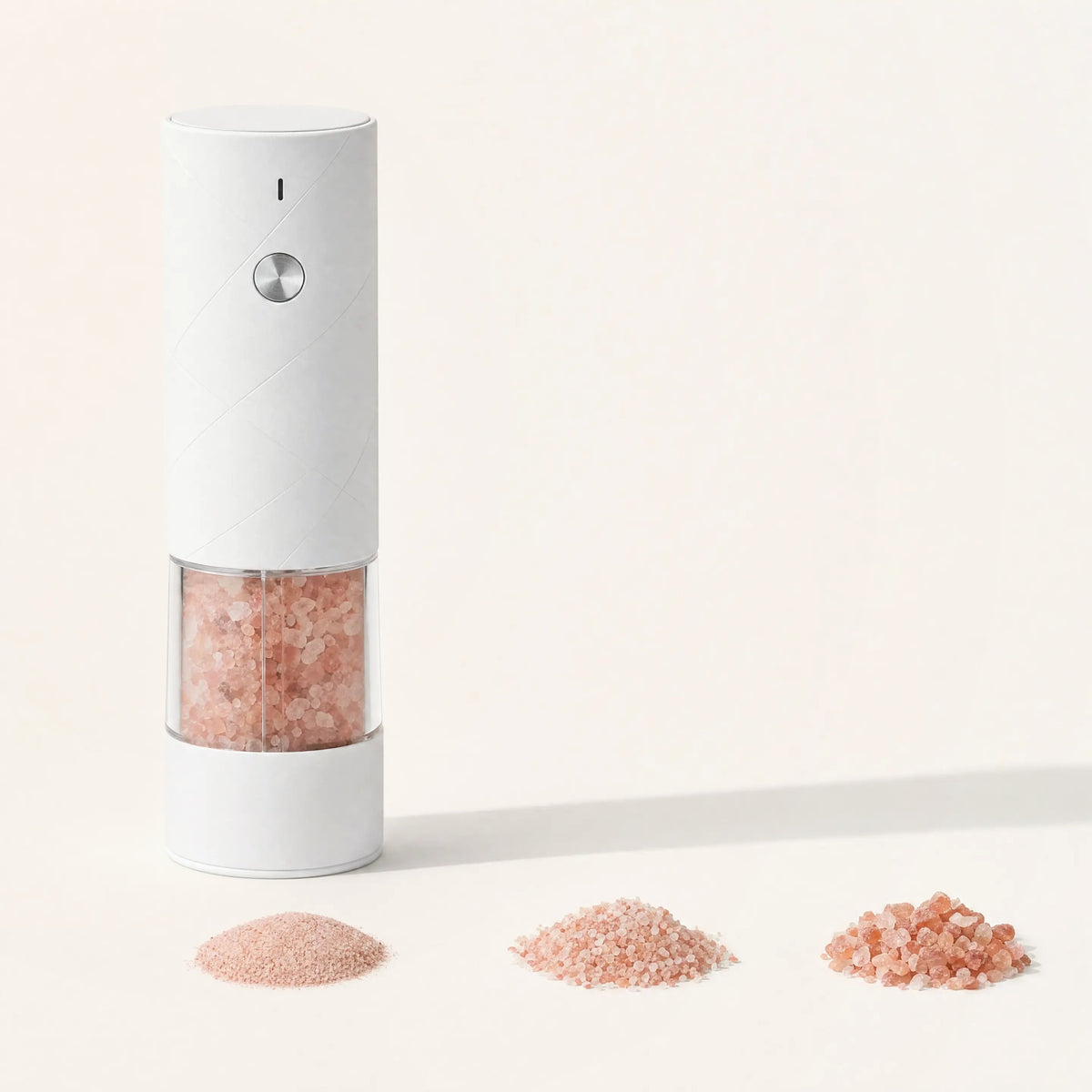 Three grind settings of pink salt from fine to coarse with the electric salt mill