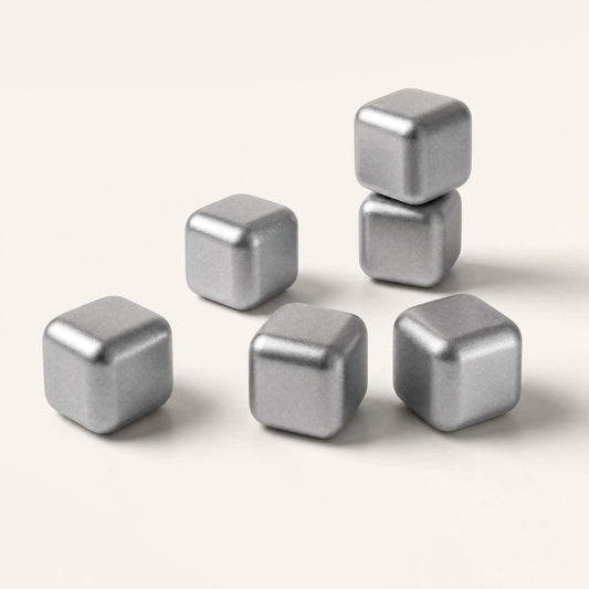 Six pure titanium ice cubes on a cream background