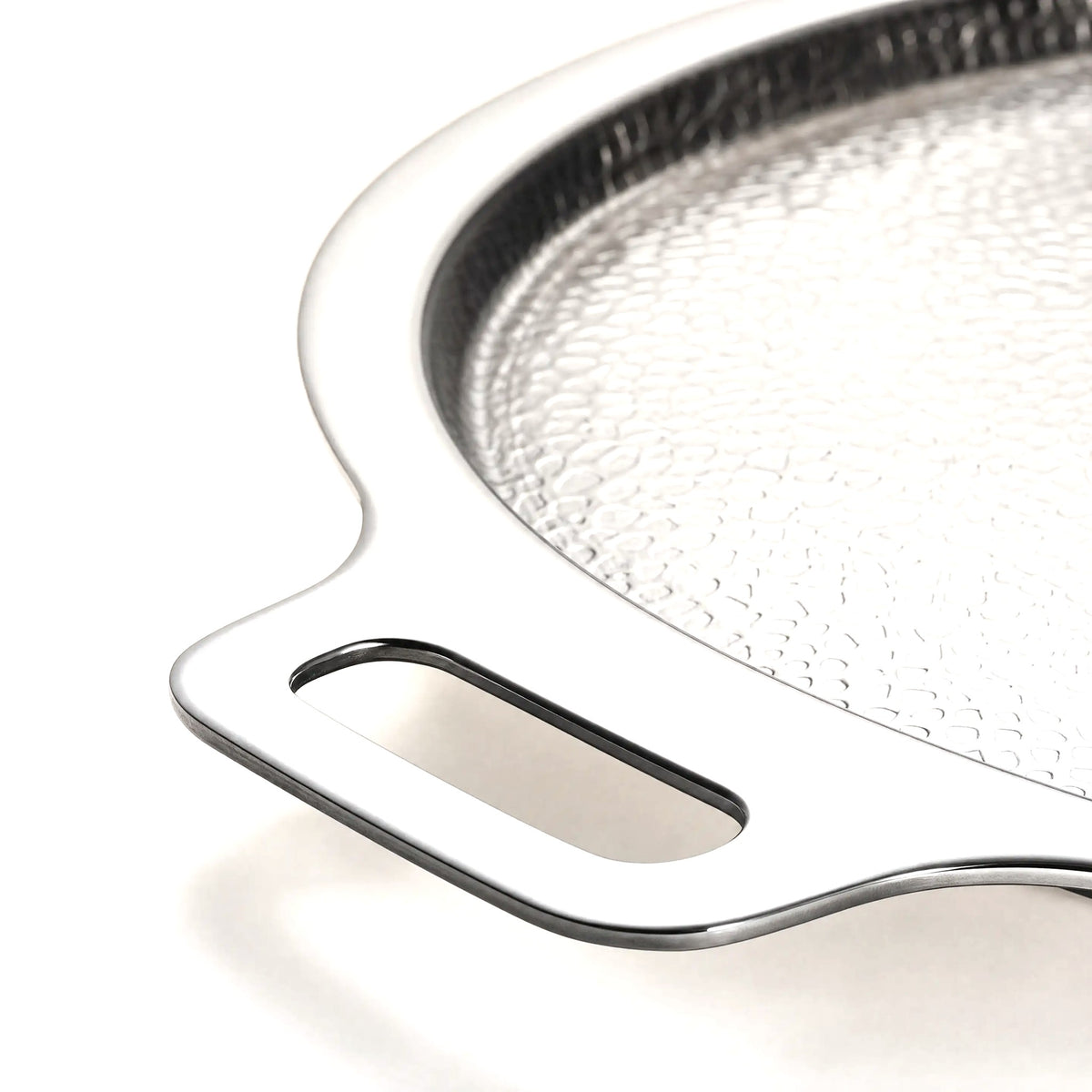 Close up of the handle and hammered surface of the titanium pizza steel
