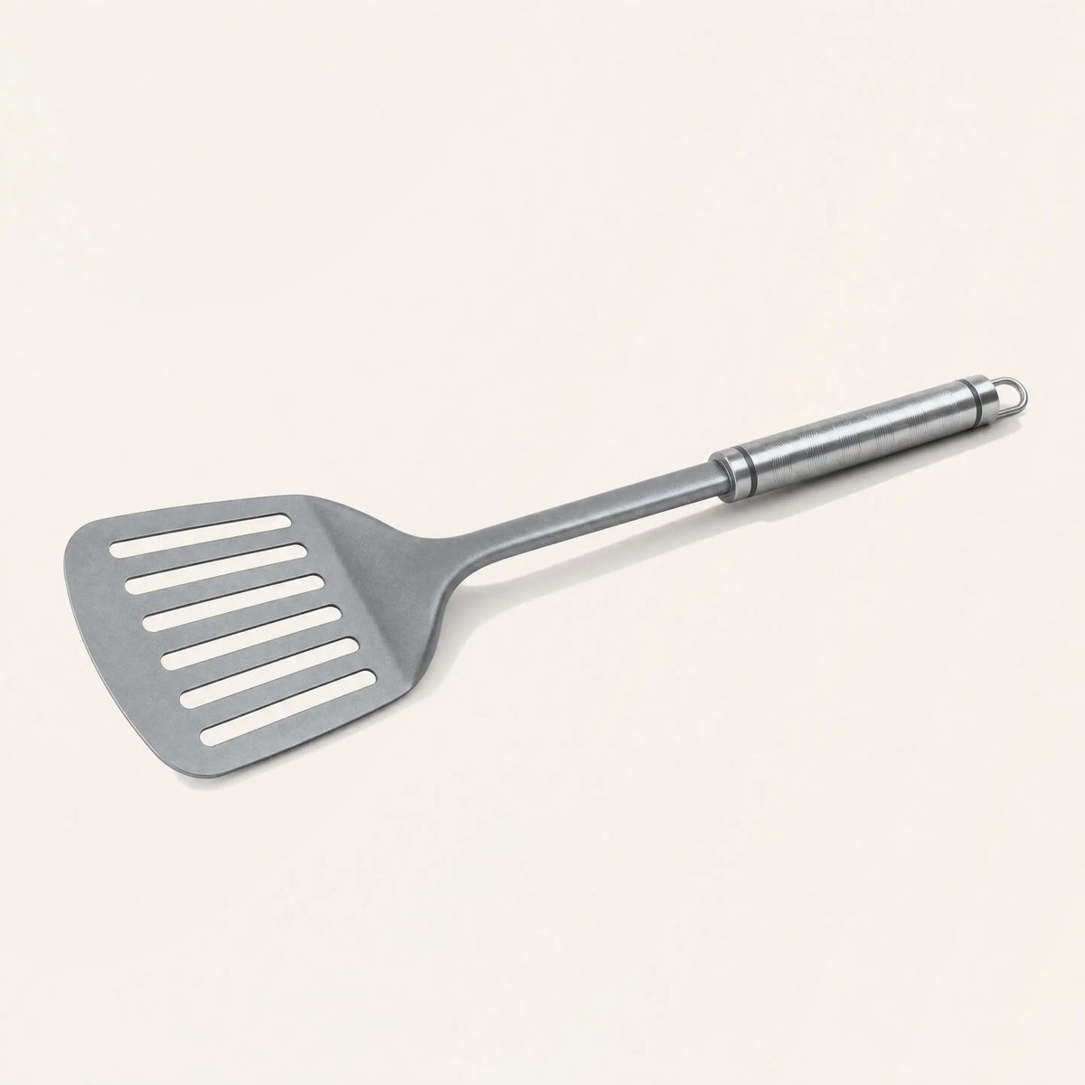 Pure titanium flipper on a cream background