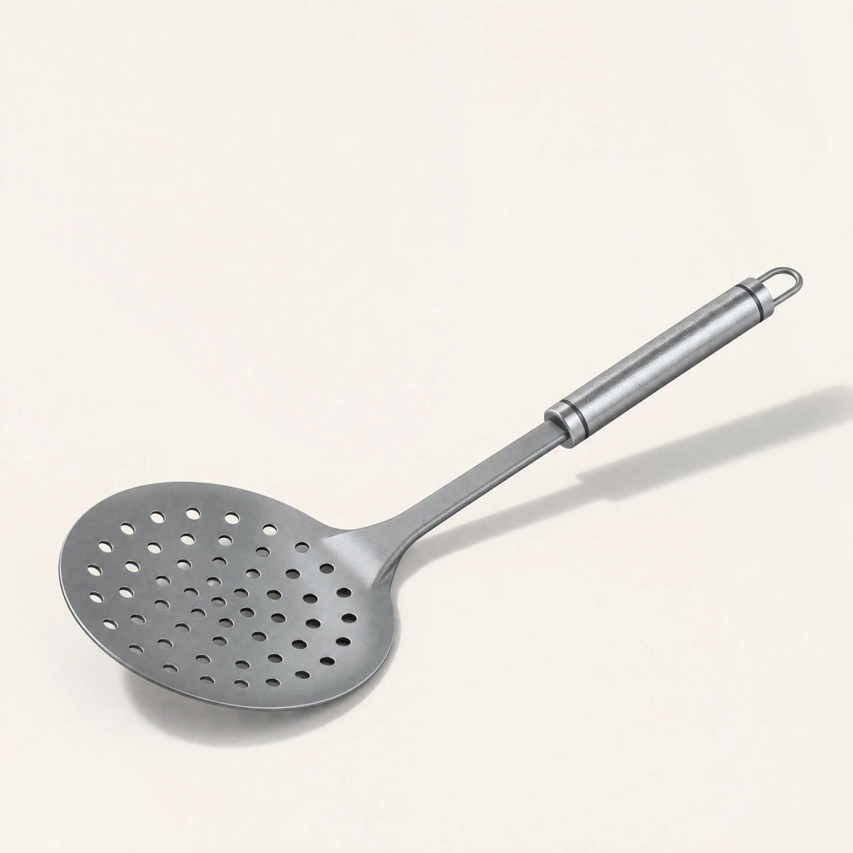 Pure titanium scooper on a cream background