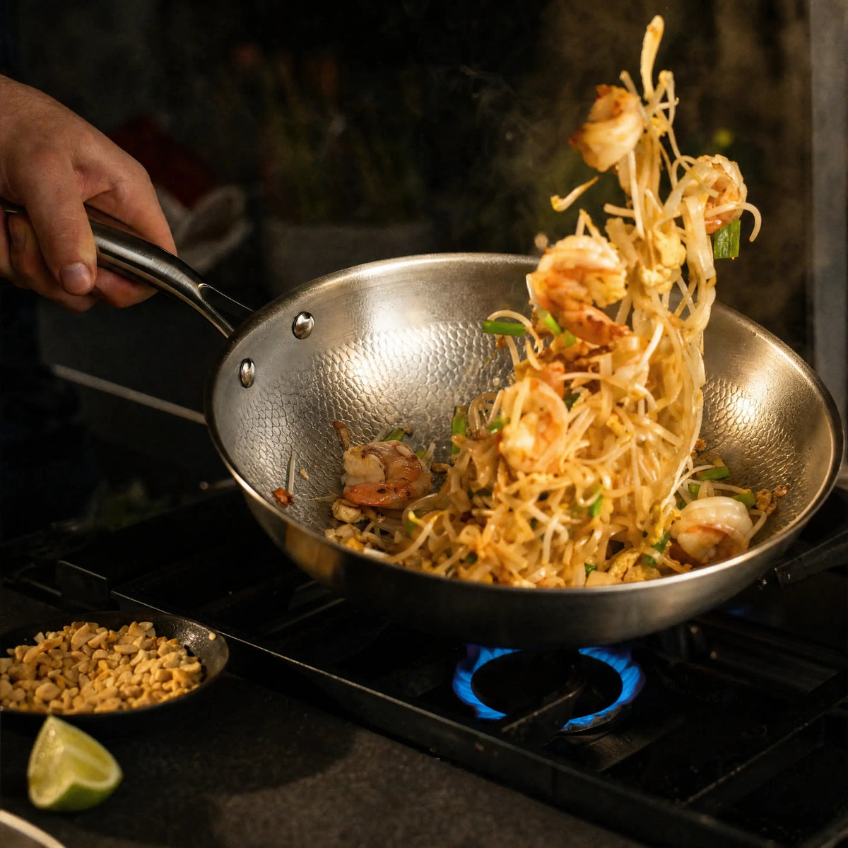 Tossing shrimp pad thai in the titanium wok over a high flame